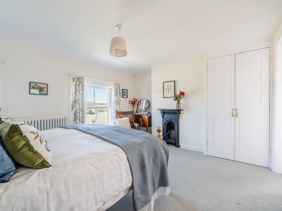 A bedroom with a bed and window at TBC