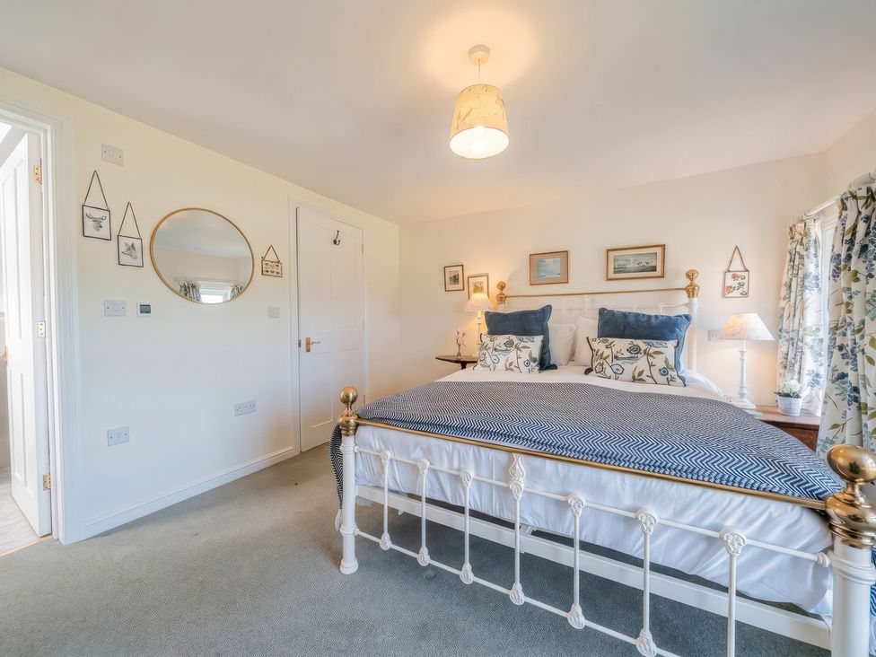A bedroom with a bed and nightstand at TBC in 