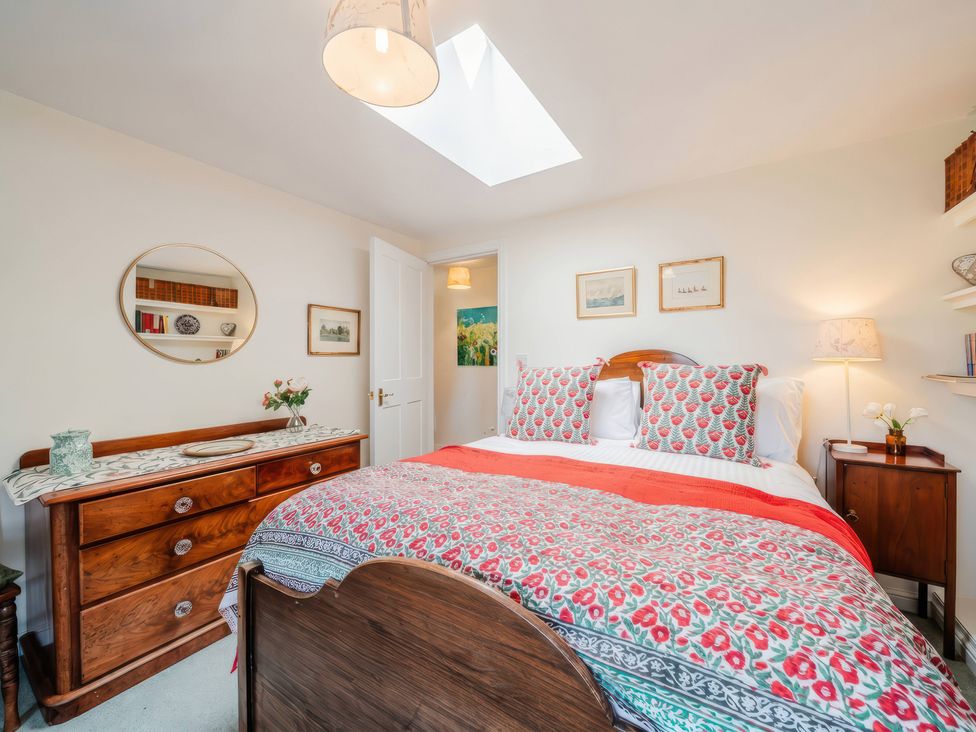 A bedroom with a bed and dresser at TBC