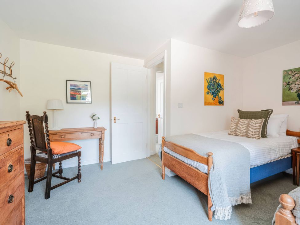 A bedroom with a bed and a desk at TBC in 