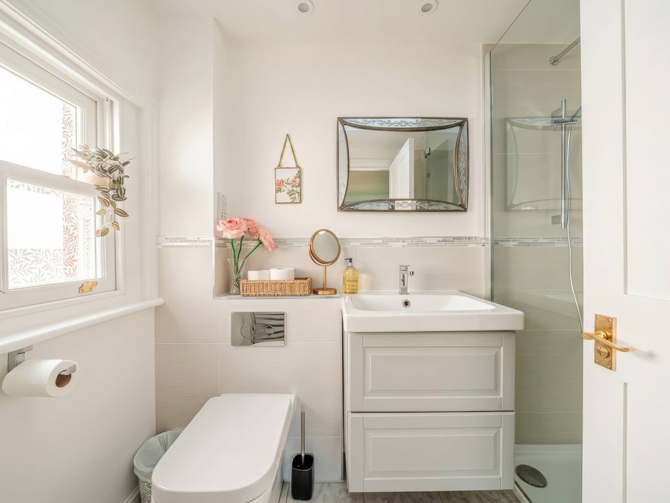 A bathroom with a sink, toilet and shower at TBC