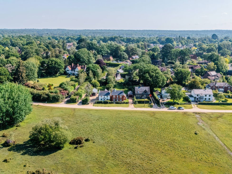 An aerial view of houses and trees with a road at TBC in 