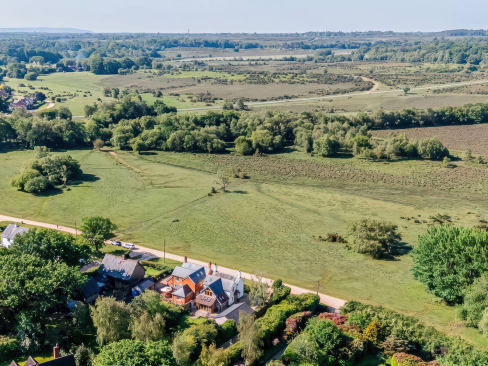 An aerial view of fields and houses at TBC