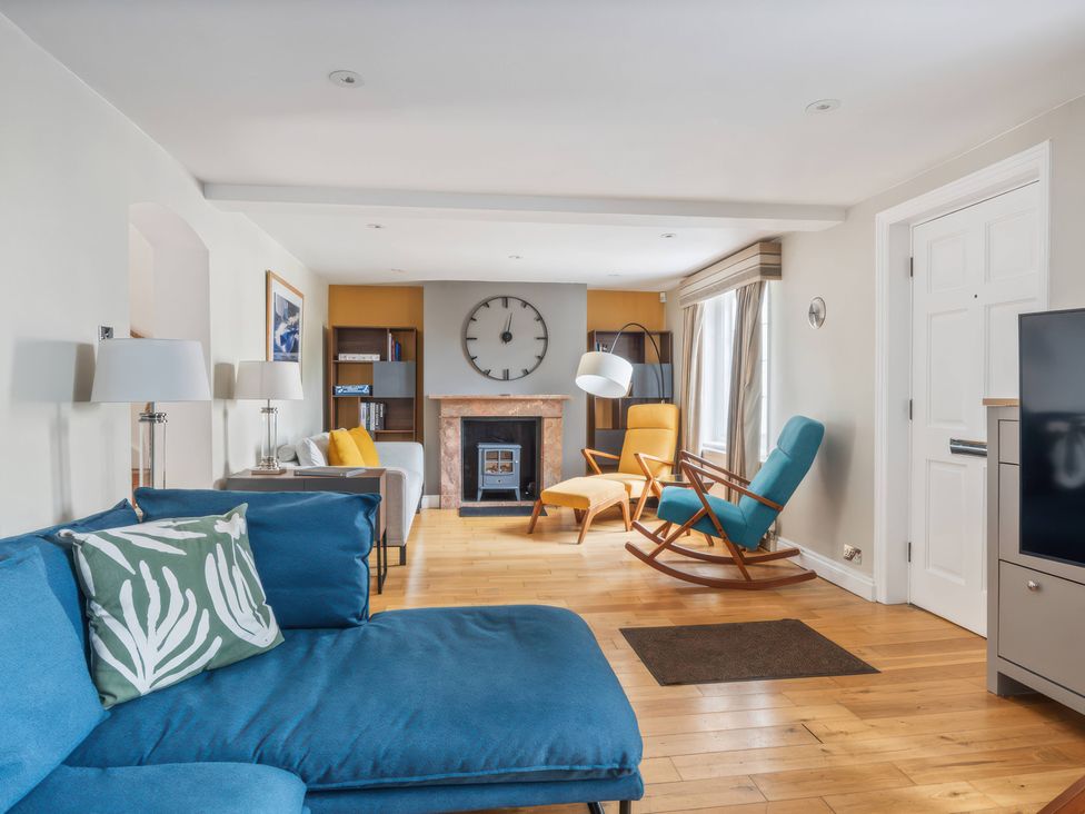 A living room with a sofa and fireplace at TBC 