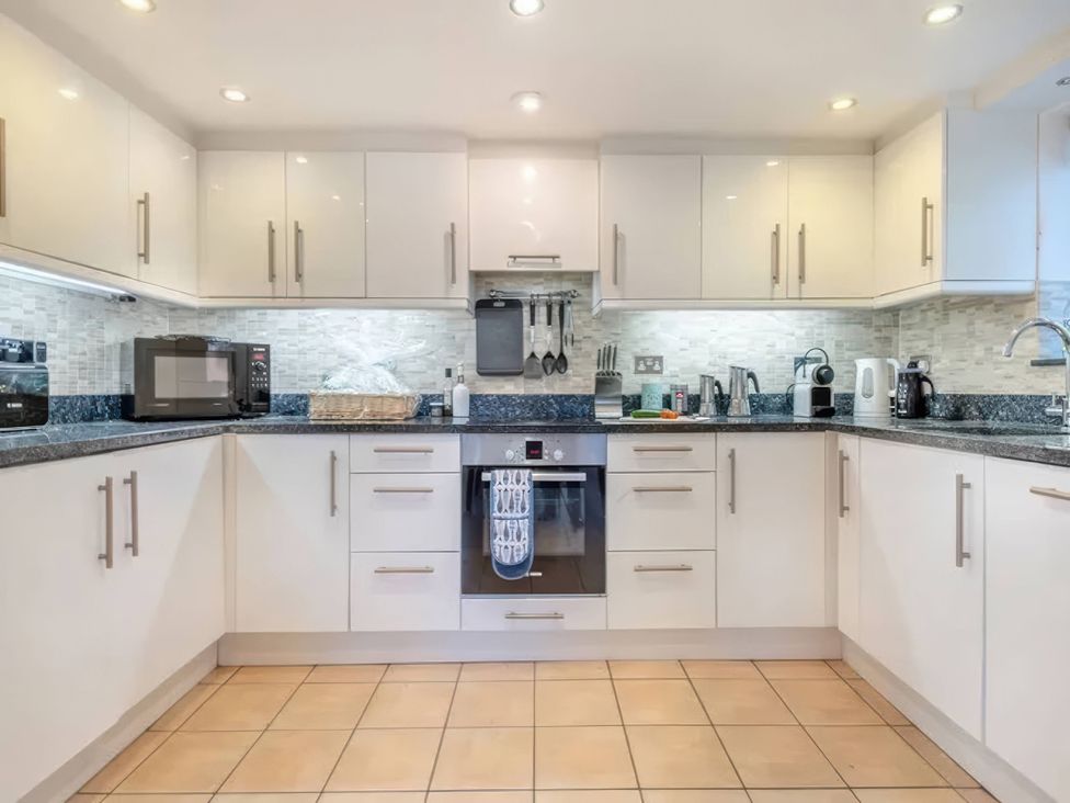 A kitchen with microwave, oven and sink at TBC 