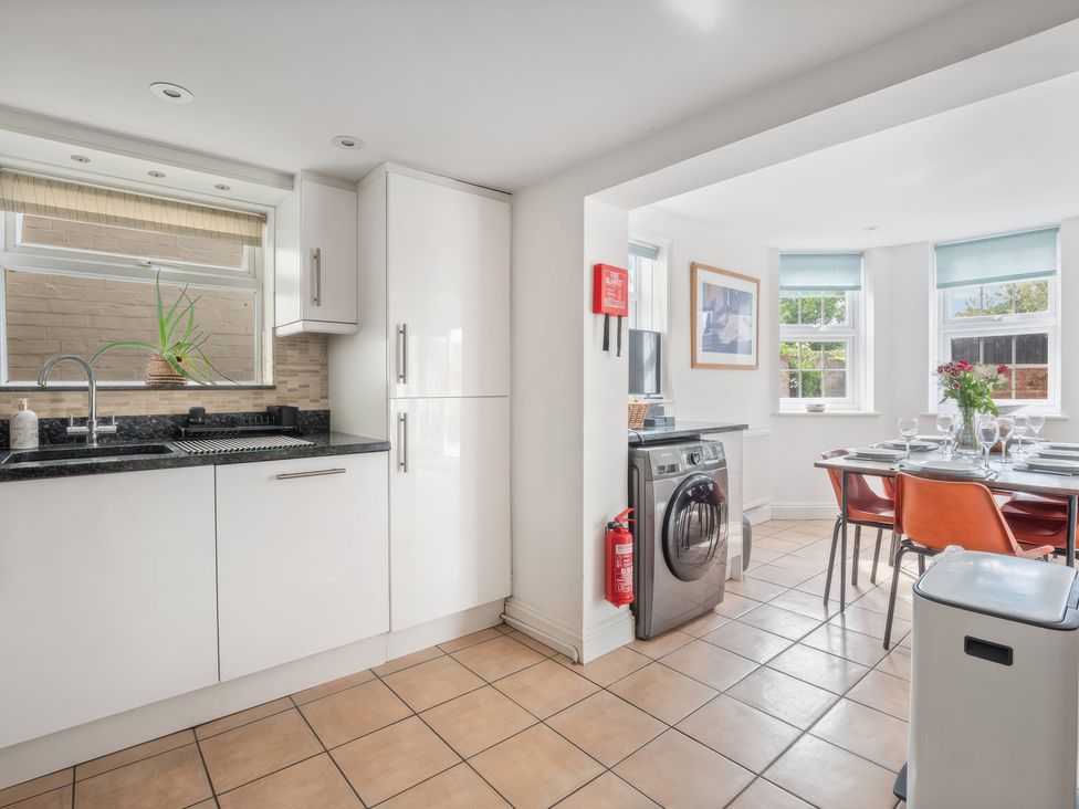 A kitchen with a sink and dining table at TBC
