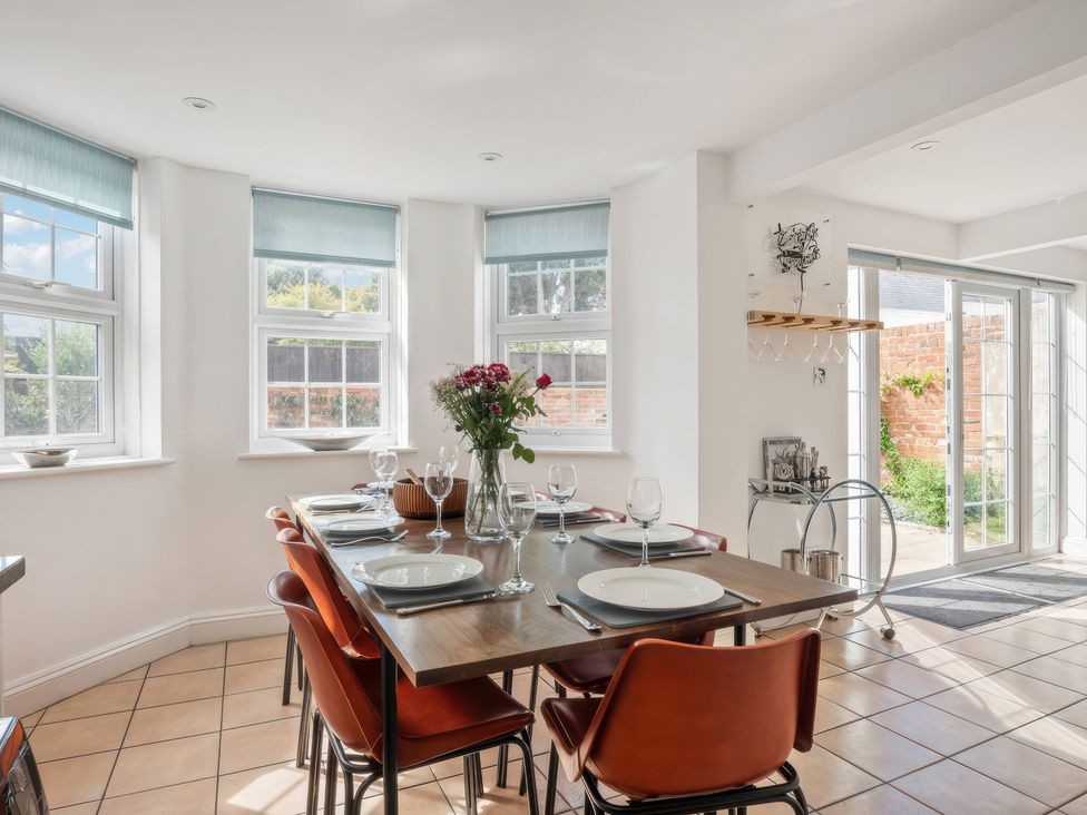 A dining room with a table set for meal at TBC 