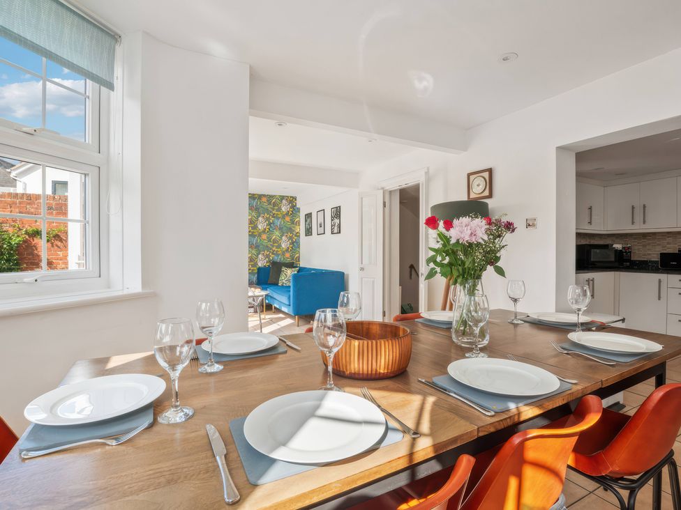 A dining room with a table set for dinner at TBC