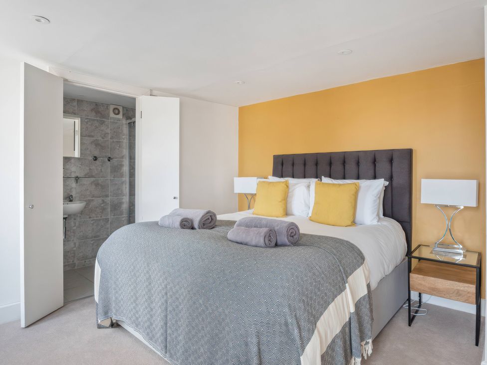 A bedroom with a bed and attached bathroom at TBC 