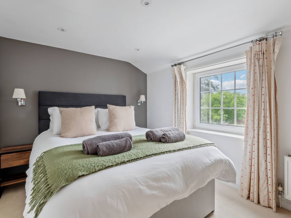 A bedroom with a bed and window at TBC in 