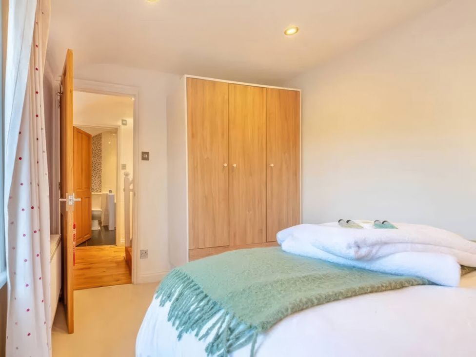 A bedroom with a bed and wardrobe at TBC 