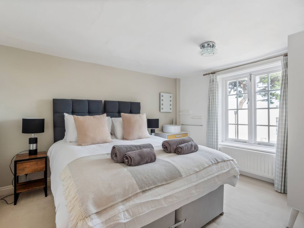 A bedroom with a bed and lamps at TBC