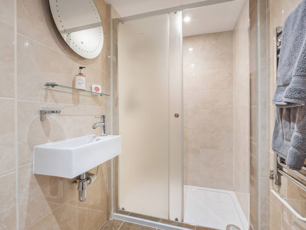 A bathroom with a wash basin and shower at TBC 