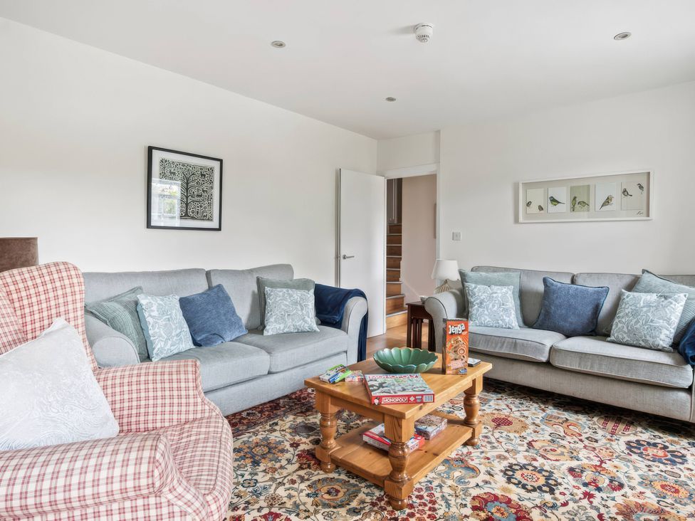 A living room with sofas coffee table and artwork at TBC 