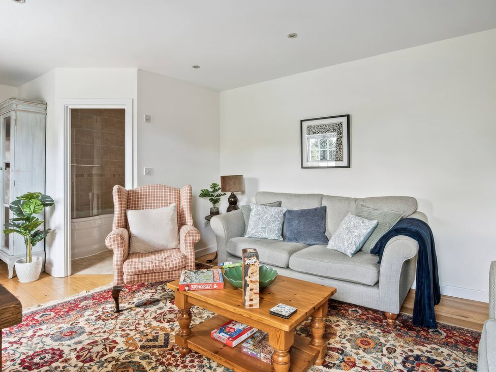 A living room with a sofa and armchair at TBC in 