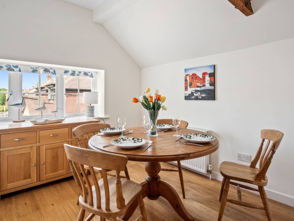 A dining room with a round table and chairs at TBC