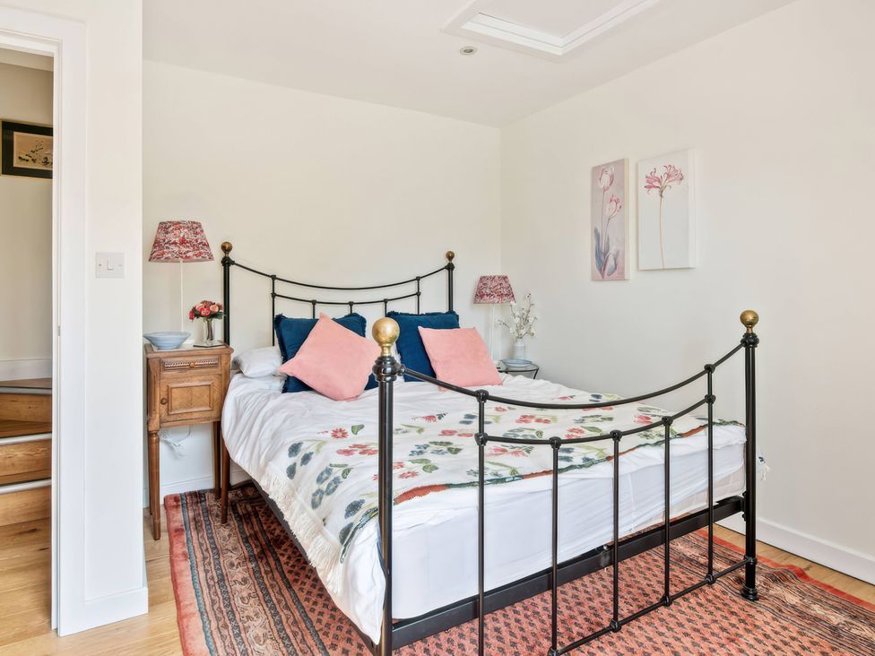 A bedroom with a bed and nightstand at TBC 