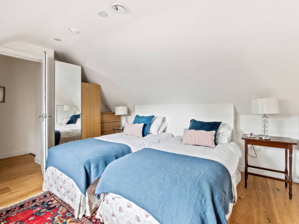 A bedroom with twin beds and a table at TBC