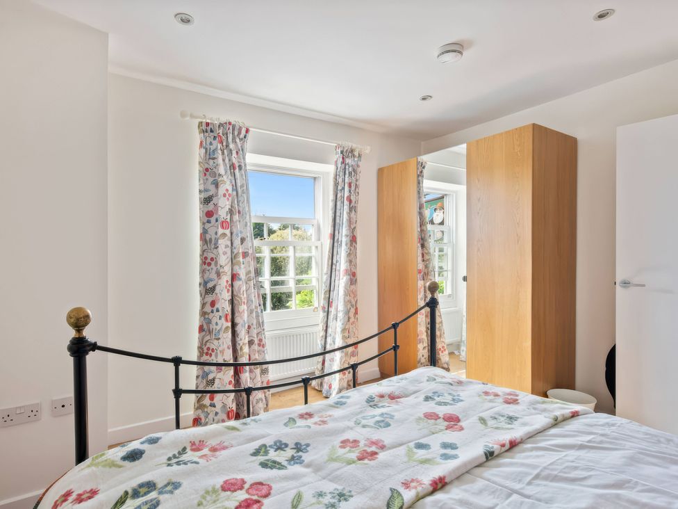 A bedroom with a bed and wardrobe at TBC 