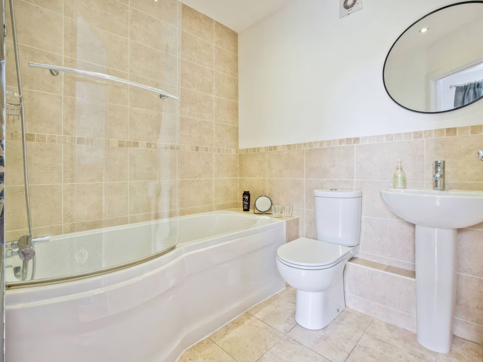 A bathroom with bathtub, toilet, and sink at TBC 