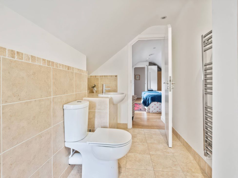 A bathroom with a toilet and sink at TBC 
