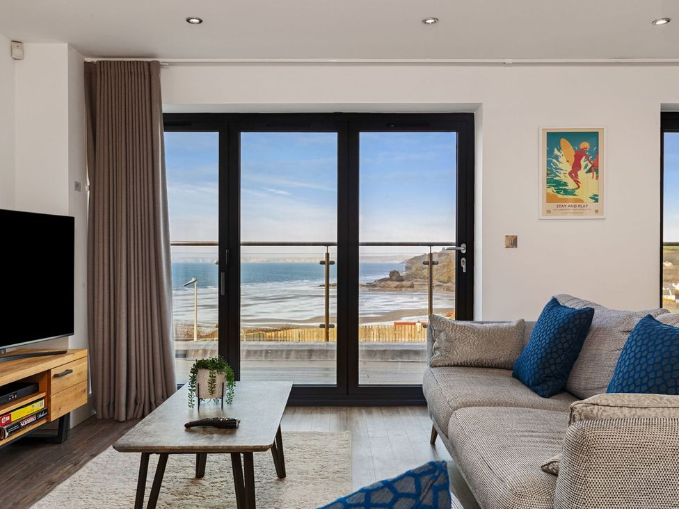 A living room with a view of the sea at One Sand Banks in Haverfordwest