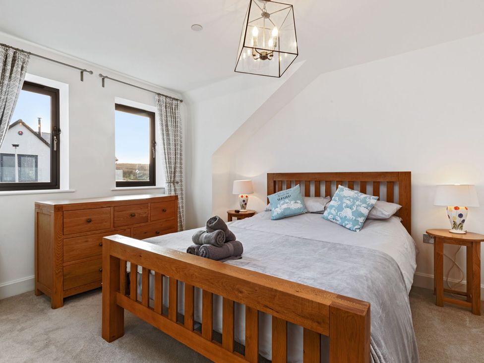 A bedroom with a bed and chest of drawers at One Sand Banks Haverfordwest
