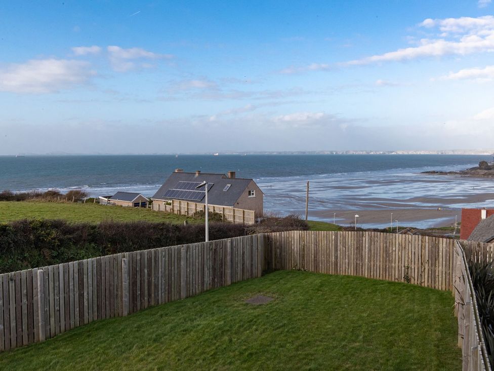 A view of the sea and grass area at One Sand Banks in Haverfordwest