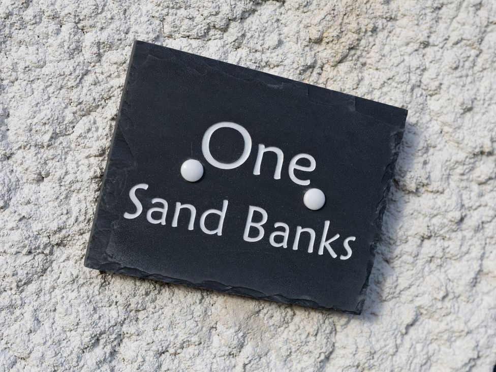 A nameplate with 'One Sand Banks' attached to a wall at One Sand Banks Haverfordwest