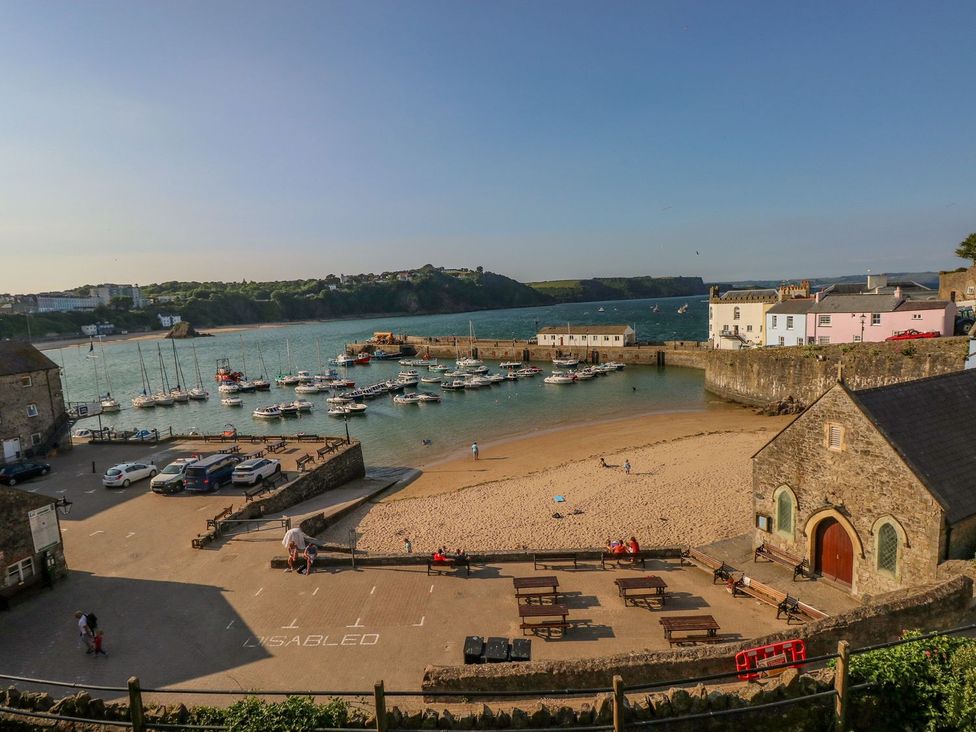 A harbor with boats and beach at One Sand Banks in Haverfordwest