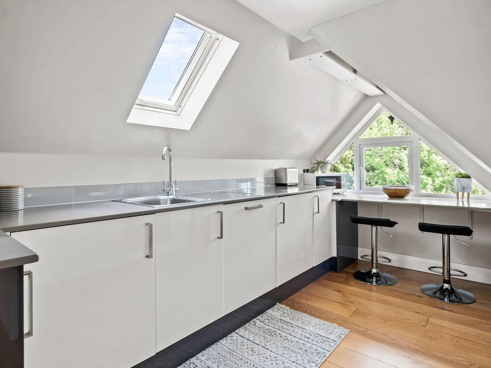 A kitchen with a sink and cabinets at TBC 