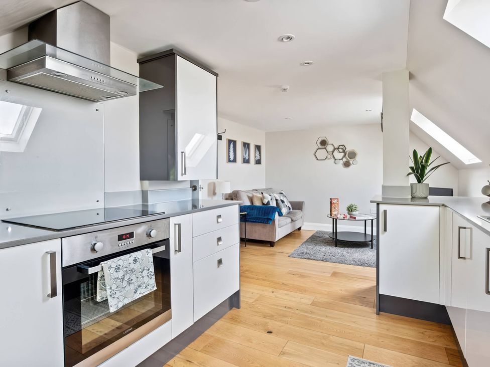 A kitchen with oven and cabinets at TBC