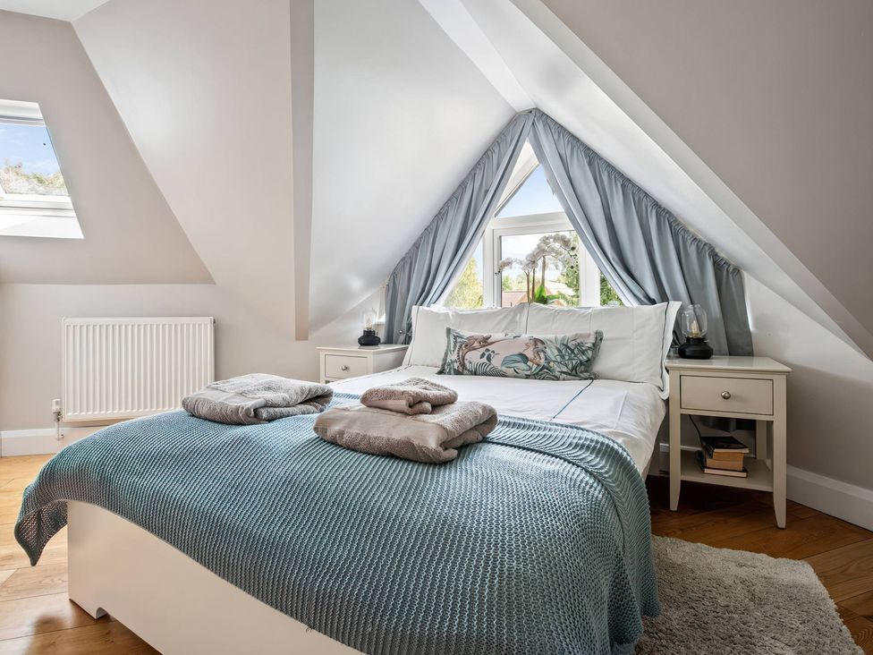 A bedroom with a bed and window at TBC 