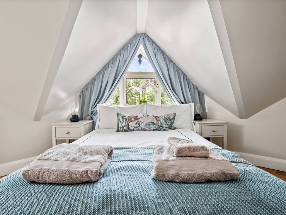 A bedroom with a bed and bedside tables at TBC 