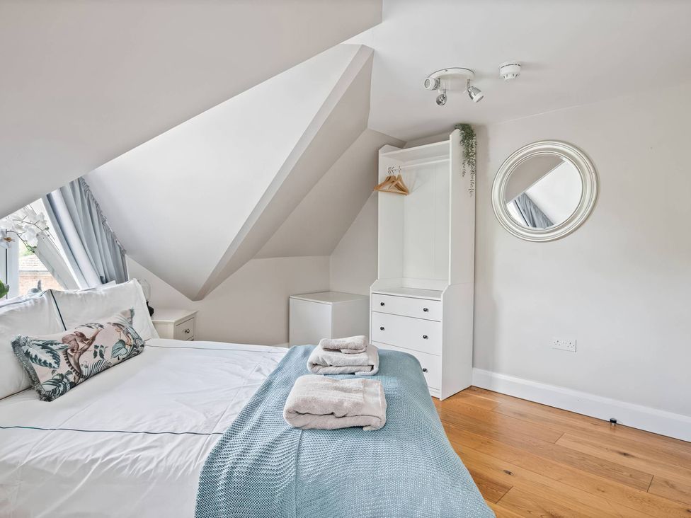 A bedroom with a bed and a dresser at TBC in 