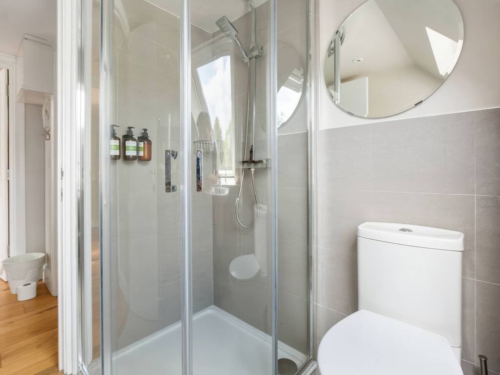 A bathroom featuring a shower and toilet at TBC 