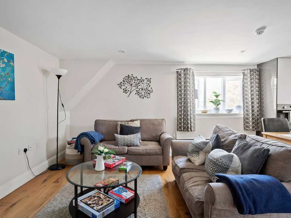 A living room with a sofa and coffee table at TBC 
