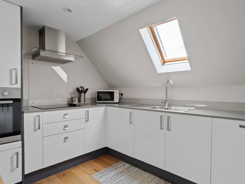 A kitchen with microwave and sink at TBC