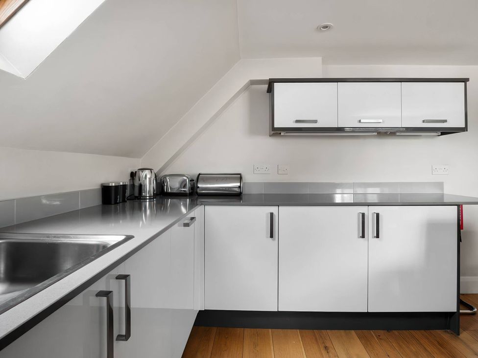 A kitchen with a sink and cabinets at TBC