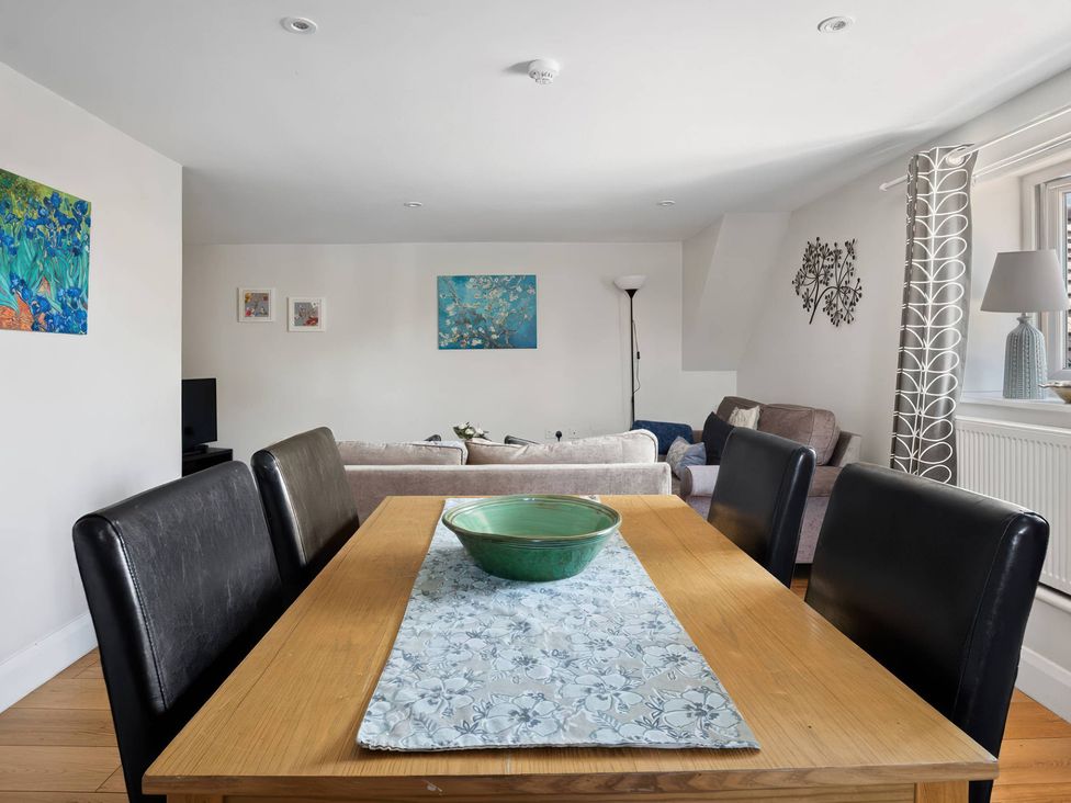 A dining room with a table and chairs at TBC in 