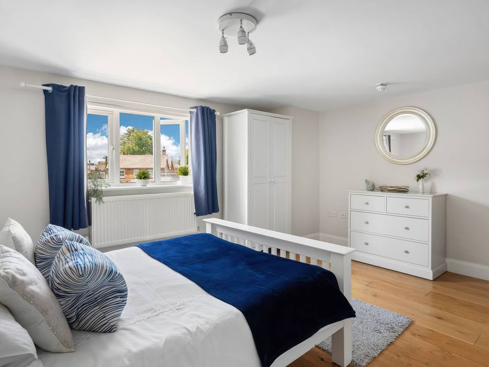 A bedroom with a bed, wardrobe, and dresser at TBC in 