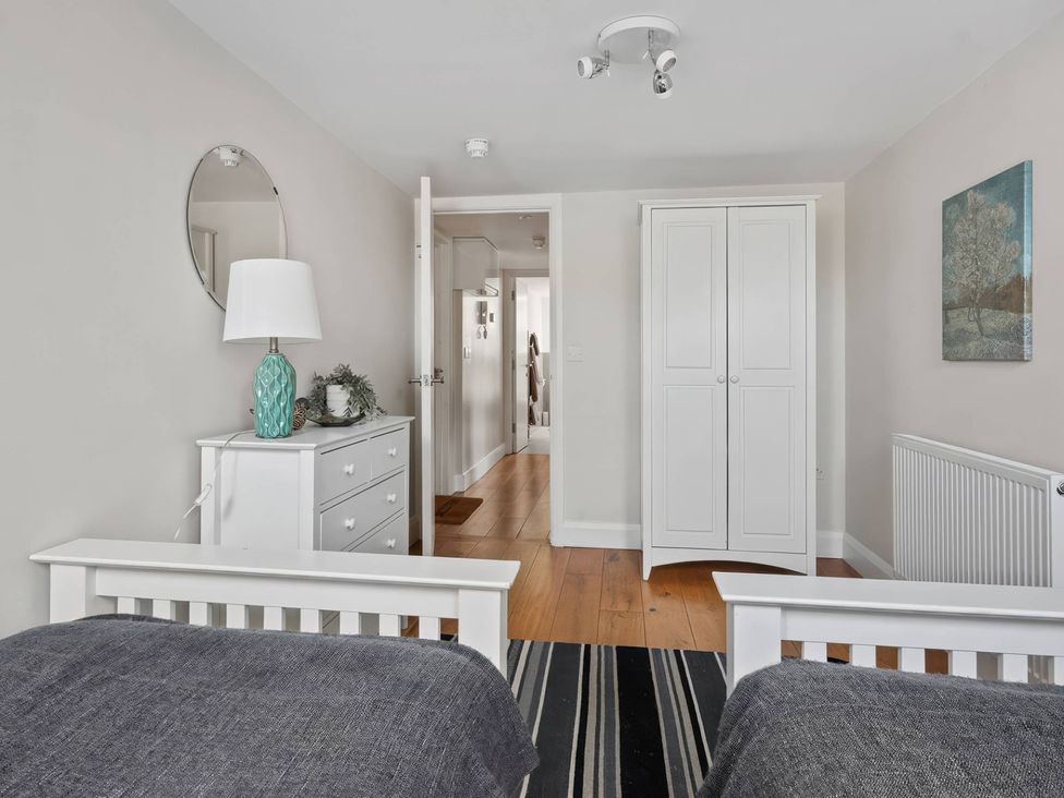 A bedroom with two beds and a dresser at TBC in 