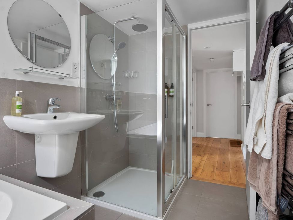 A bathroom with a shower and sink at TBC