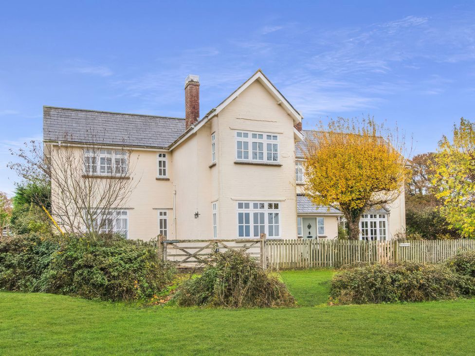 A house with a fenced yard and trees at TBC in 