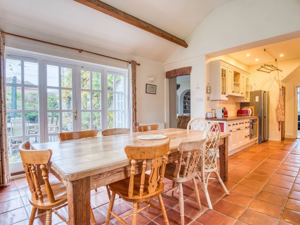 A kitchen with a dining table and chairs at TBC