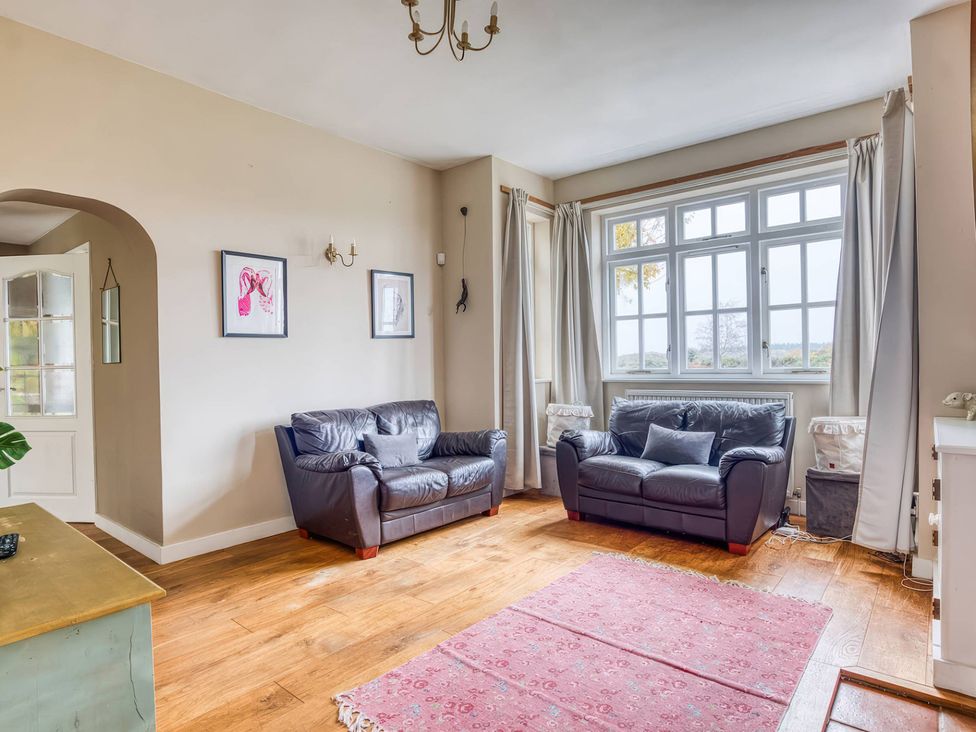 A living room with two sofas and a rug at The Old Barn in Manchester