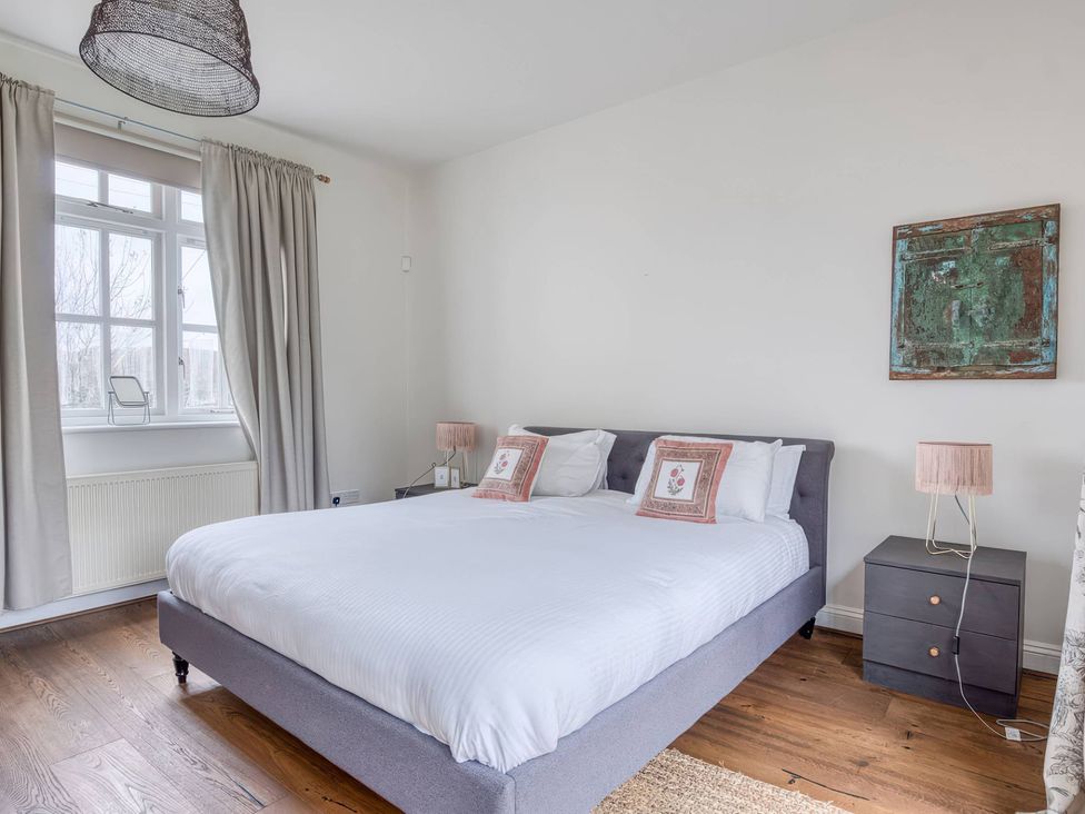 A bedroom with a bed and bedside table at TBC in 