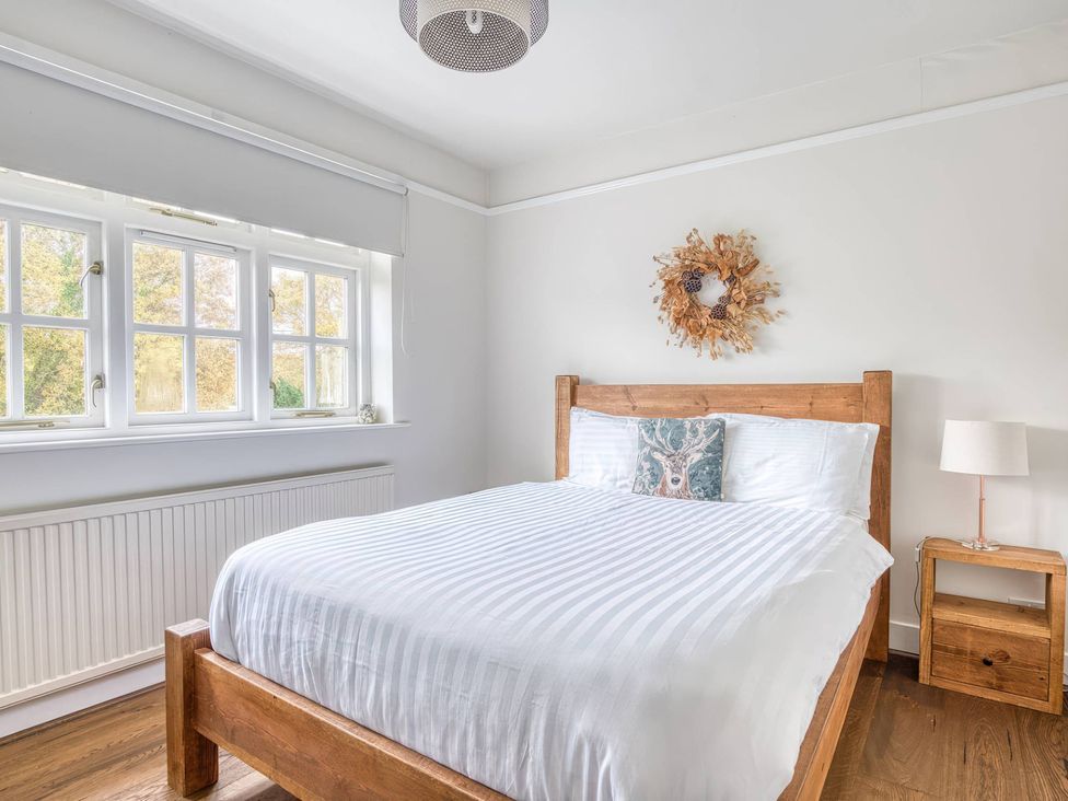 A bedroom with a bed and bedside table at TBC in 