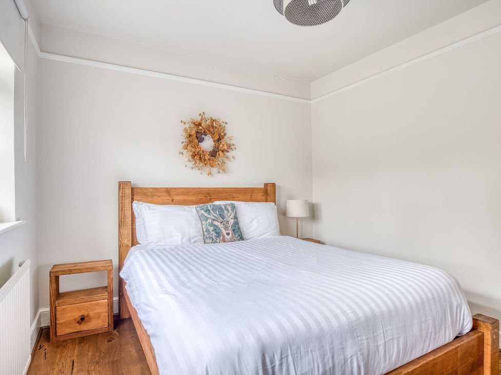A bedroom with a bed and nightstand at TBC