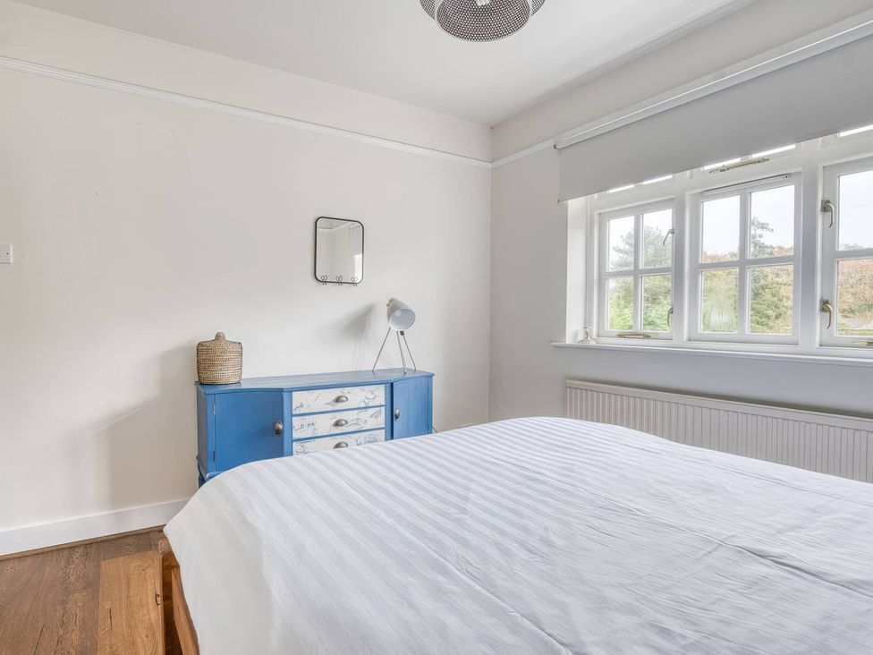 A bedroom with a bed and blue dresser at TBC 